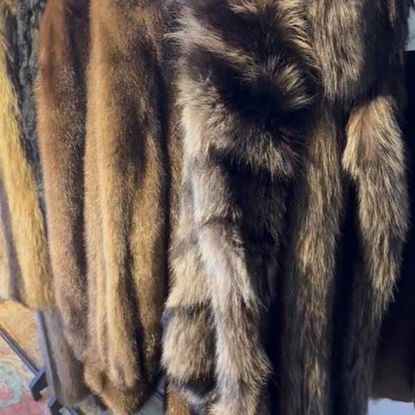 Vintage fur coats hanging on the rack at Blueprints Vintage
